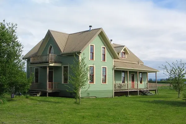 Side view of the restored green Craftsman home