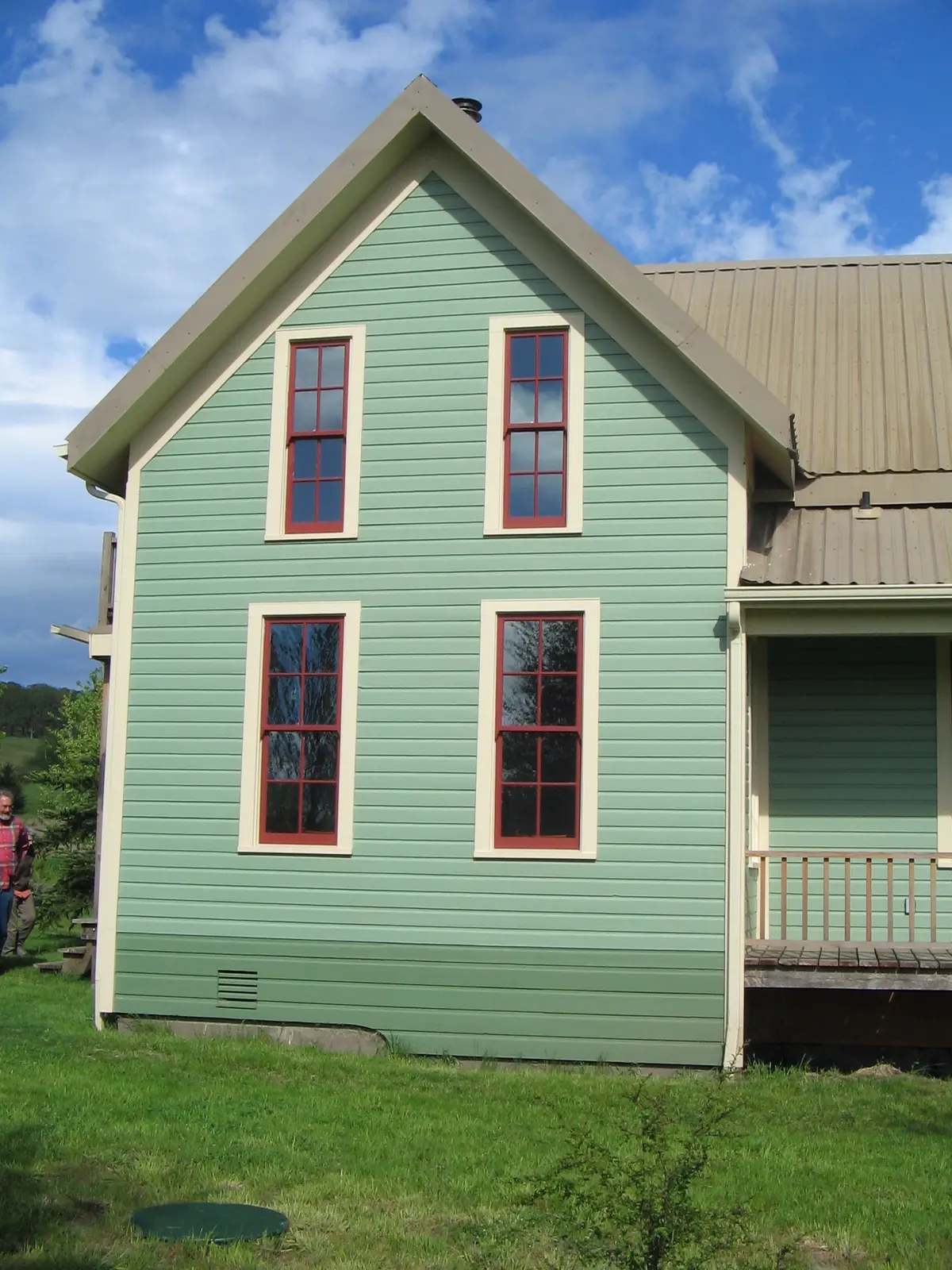 Tall red-trimmed custom windows on the Craftsman home