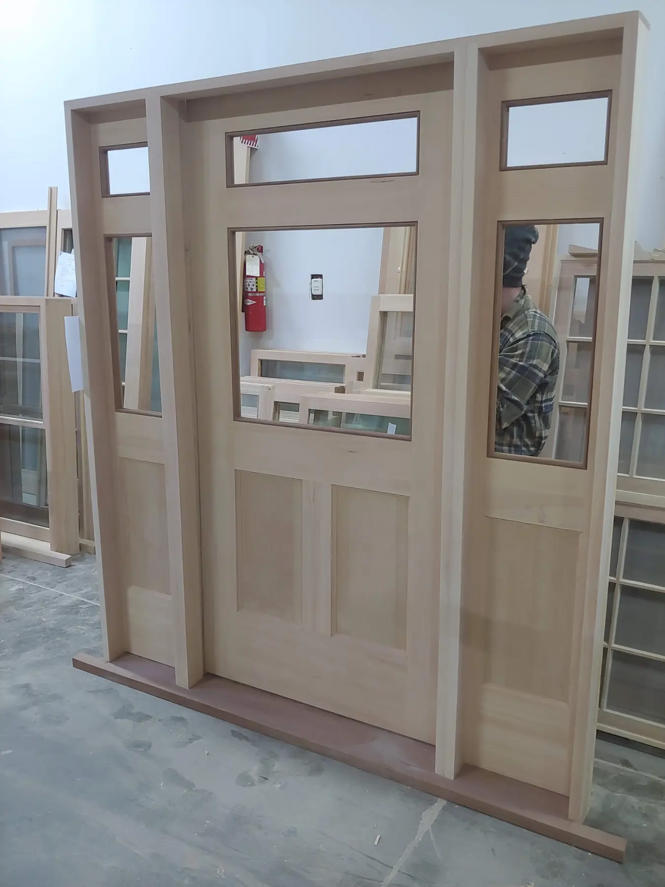 Custom entry door system with sidelights and transom under construction in the Wooddale shop