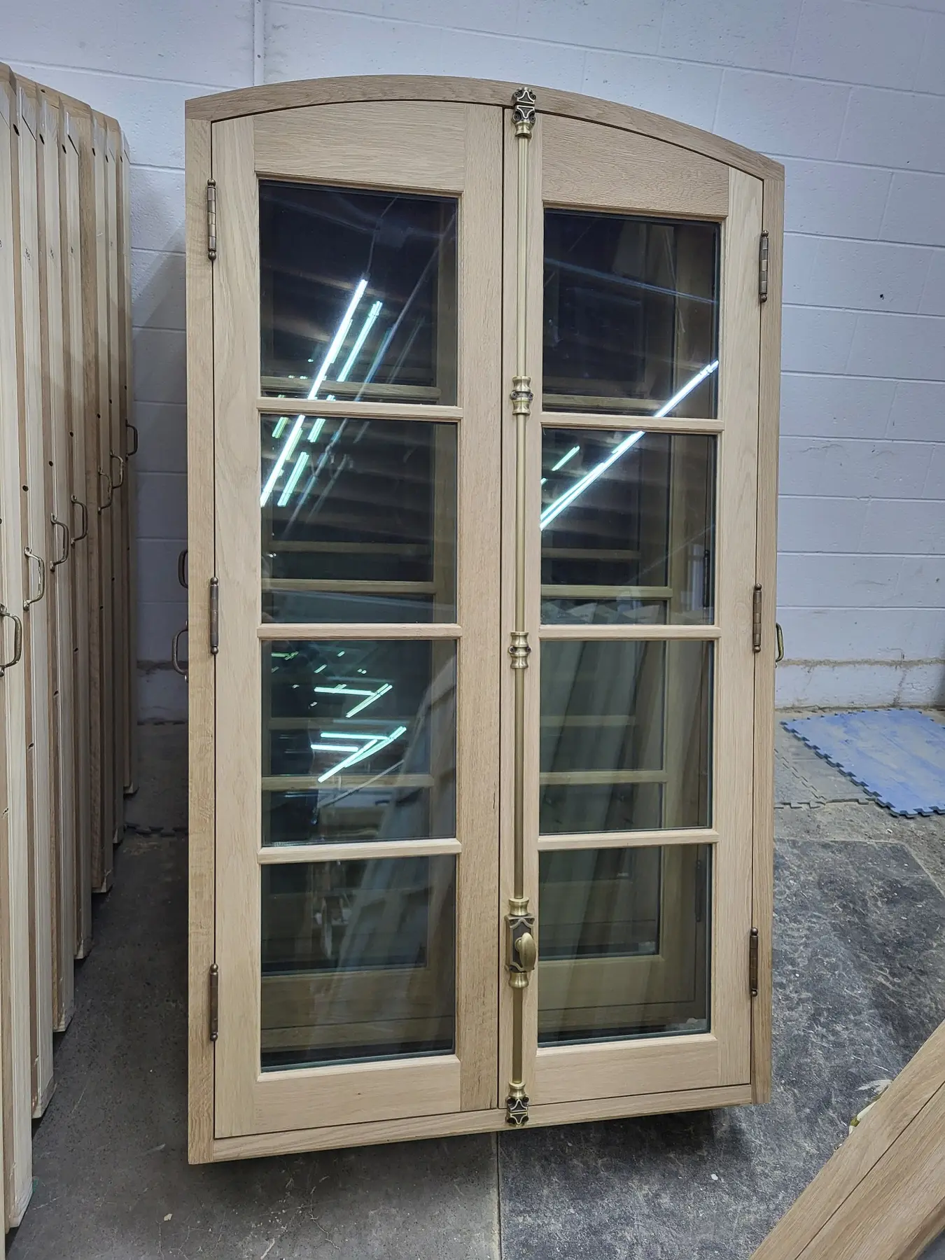 Curved-top custom wood windows in the Wooddale shop