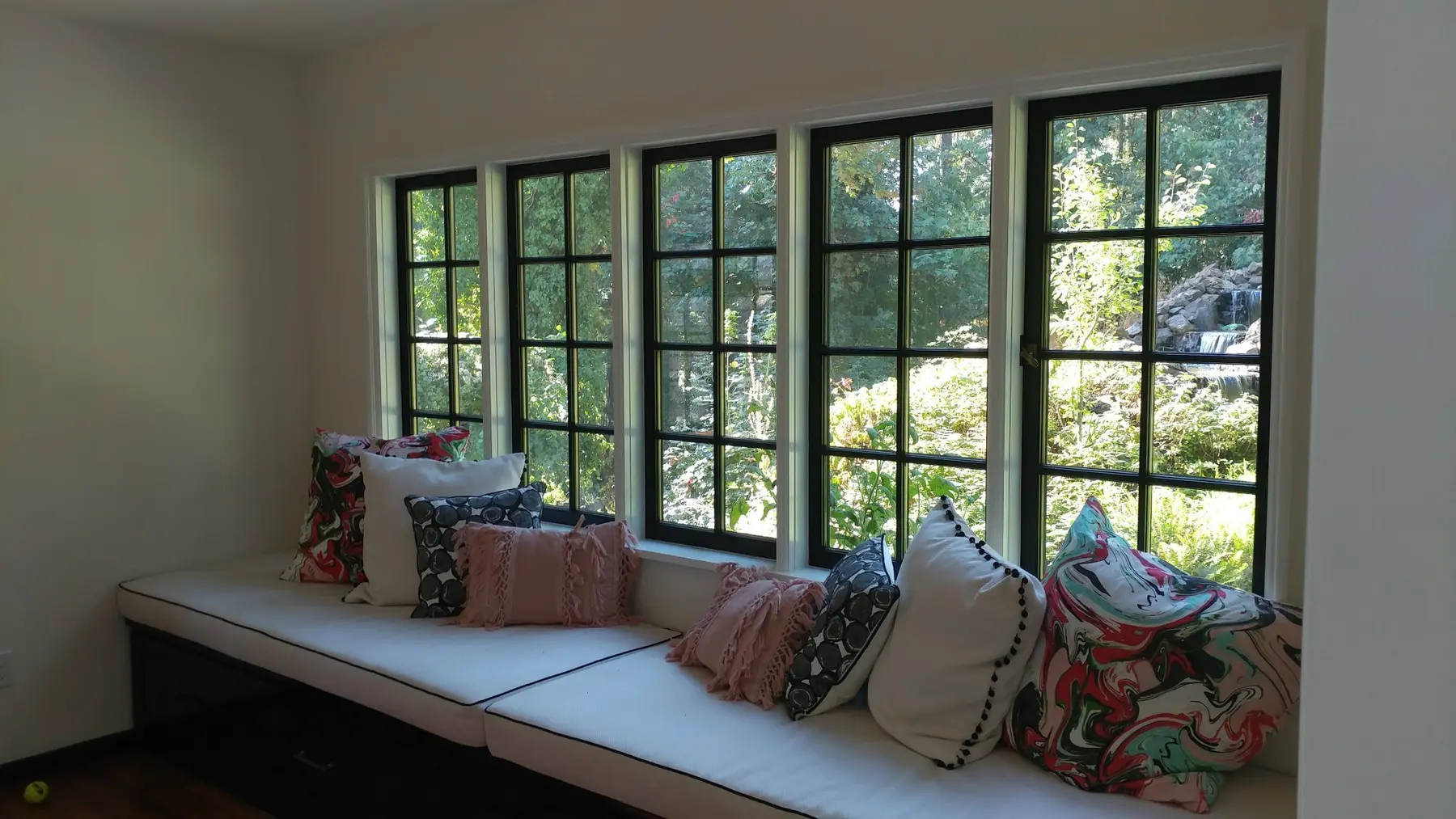 Window seat surrounded by custom wood windows